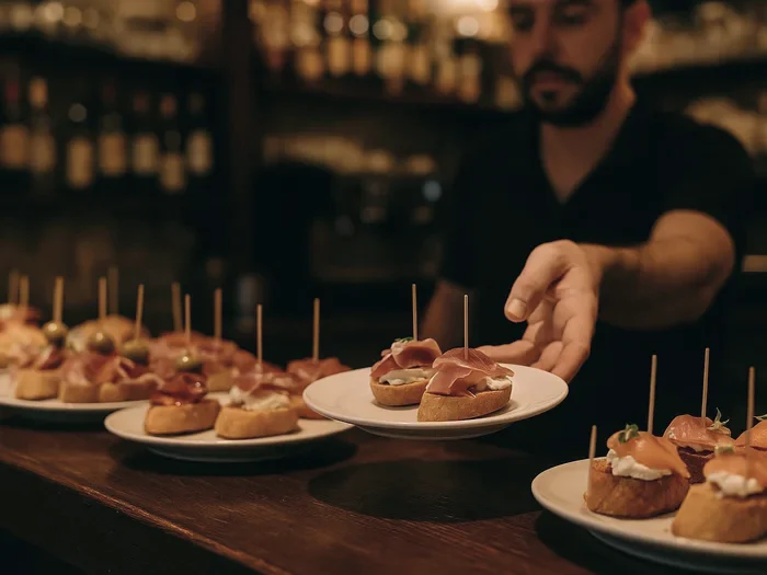 Pintxos served on plates at a bar counter