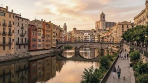 Coloured houses along the Onyar river in Girona, with the cathedral above the old town